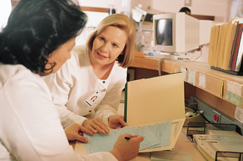 Photo of a female nurses discussing a patient's medical records